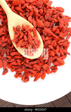 composition of dried goji berries on a wooden spoon Stock Photo