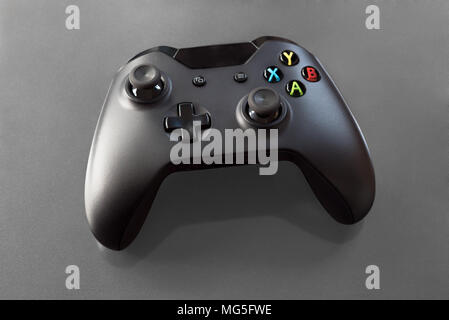 Handheld computer gamepad for young gamers playing virtual video games for fun. Stock Photo