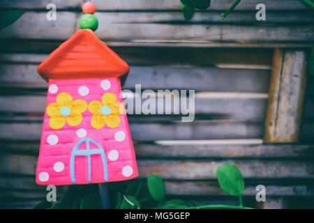 Ceramic House Hanging in The Park with Bamboo Fence Background. Stock Photo