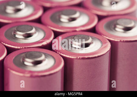 low angle closeup of pink electric batteries and accumulators AAA AA with selective focus on top Stock Photo
