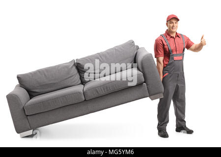 Full length portrait of a mover lifting a couch and making a thumb up sign isolated on white background Stock Photo