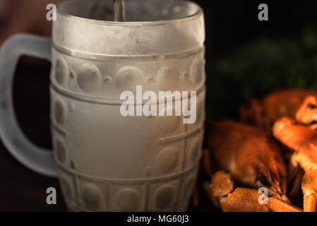 Boiled crayfish with dill and cool beer on wooden background Stock Photo