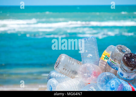 Plastic bottles and other rubbish / pollution on a beach in Morocco with sea in distance Stock Photo