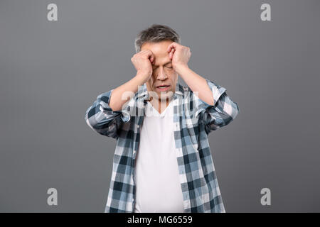Nice tired man touching his face Stock Photo