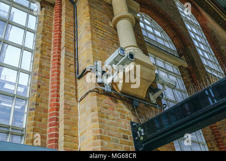 LONDON, UK - APRIL 6, 2018:  Security cameras mounted up on a wall in Liverpool Street mainline station. Stock Photo