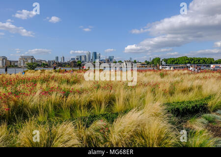 GREENWICH, LONDON, UK - AUGUST 10TH, 2017: Canary Wharf and River Thames with colourful flower beds in the foreground. Stock Photo