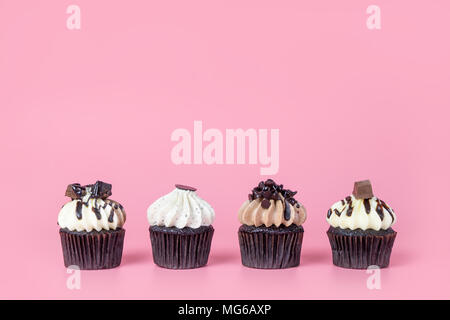 Four mini Chocolate Cucpake muffin on pink background with copy space Stock Photo