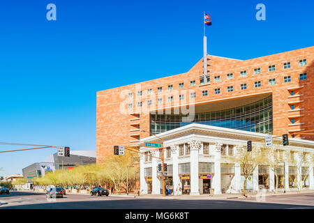 People walk in front of the Sticklers cafe with the Phoenix Municipal Court building visible in the background in downtown Phoenix Arizona USA. Stock Photo