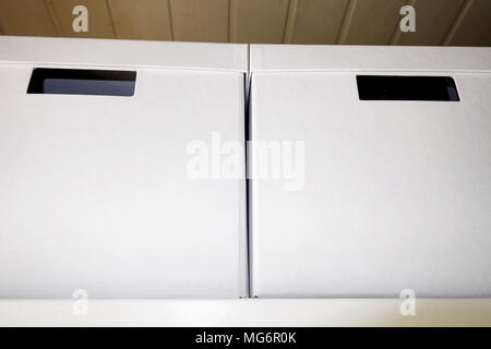 Two white storage boxes on top of a wardrobe Stock Photo