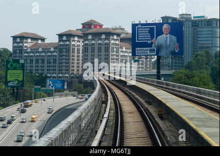 A huge billboard with the image of Malaysian prime minister, Najib Razak of the Barisan National Party is seen in the background ahead of the 14th general election in Kuala Lumpur, Malaysia on April 27, 2018. According to supporters of Najib Razak, the MRT is one of the greatest achievements during the prime minister's term. The 14th general election of Malaysia will be held on May 9. Stock Photo