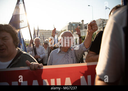 Athens, Greece. 27th Apr, 2018. Protesters seen holding a large banner during the demonstration.First gathering at the Unknown Soldier's Monument, the march has been made until the German Embassy to protest for compensation of the World War II from Germany as several massacre perpetuated by German soldiers back in 1943 were committed. Credit: Vangelis Evangeliou/SOPA Images/ZUMA Wire/Alamy Live News Stock Photo