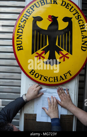 Athens, Greece. 27th Apr, 2018. Protesters seen hanging notes on the German Embassy's wall during the demonstration.First gathering at the Unknown Soldier's Monument, the march has been made until the German Embassy to protest for compensation of the World War II from Germany as several massacre perpetuated by German soldiers back in 1943 were committed. Credit: Vangelis Evangeliou/SOPA Images/ZUMA Wire/Alamy Live News Stock Photo