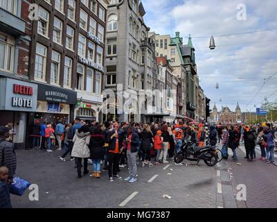 Amsterdam, The Netherlands - April 27th, 2018 : King's Day - People eagerly waiting for the tasty and famous fries; King's Day (formerly Queen's Day) festivities invite locals and visitors alike to soak up Amsterdam's open-air fun. In the streets, canals, parks and everywhere in between, the city is bursting with orange as Amsterdammers enjoy the biggest street party of the year.;  Credit: Bala Divakaruni/Alamy Live News Stock Photo