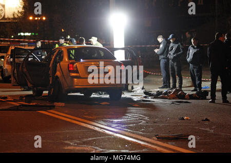 Kiev, Ukraine. 28th Apr, 2018. Ukrainian police officers investigate the scene of a grenade explosion within a car, in Kiev, Ukraine, on 28 April 2018. According to local media reports, one unidentified man was killed and another one injured after a grenade exploded inside of a car. Credit: Serg Glovny/ZUMA Wire/Alamy Live News Stock Photo