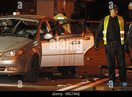 Kiev, Ukraine. 28th Apr, 2018. Ukrainian police officers investigate the scene of a grenade explosion within a car, in Kiev, Ukraine, on 28 April 2018. According to local media reports, one unidentified man was killed and another one injured after a grenade exploded inside of a car. Credit: Serg Glovny/ZUMA Wire/Alamy Live News Stock Photo