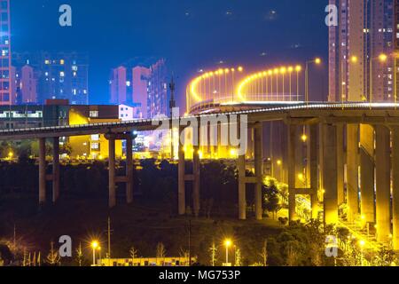 Chongqin, Chongqin, China. 27th Apr, 2018. Chongqing, CHINA-27th April 2018: Chongqing, China's newest municipality, has been given the role of serving as a bridge between China's developed eastern coastal areas and the economically backward west regions.Essentially a mountain city, Chongqing is surrounded on all sides by steep hills which lock the fog and mist in the basin. Apart from the surrounding mountains, Chongqing is also embraced by the Yangtze and Jialing rivers, both passing through the downtown area, providing a touch of nature to the otherwise unrelieved industrial views through Stock Photo