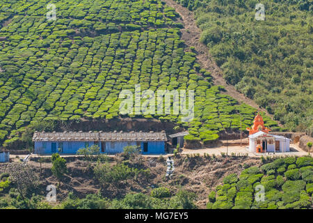 Accommodation for estate workers with a Hindu temple on a tea plantation near Valparai in Tamil Nadu state Stock Photo