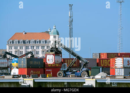 Reach stacker carrying intermodal cargo container on quay in the port of Zeebrugge / Zeebruges along the North Sea coast, West Flanders, Belgium Stock Photo