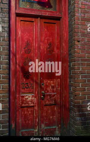 Red door at 23 1/2 Fan Tan Alley, Chinatown, Victoria, British Columbia, Canada. Stock Photo