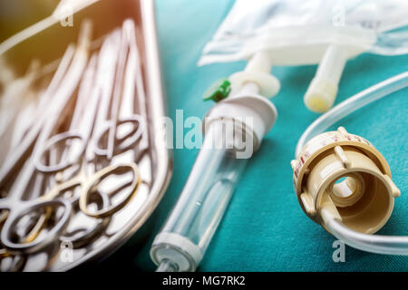 Dial flow next to a syringe at a hospital table, conceptual image Stock Photo