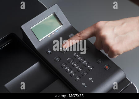 Woman's hands pressing button on Control panel laser color printer close up Stock Photo