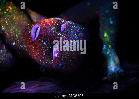 Portrait of Beautiful Fashion Woman in Neon UF Light. Model Girl with Fluorescent Creative Psychedelic MakeUp, Art Design of Female Disco Dancer Model in UV Stock Photo