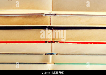 stack of old books lying on top of each other. A pattern from books as a background Stock Photo