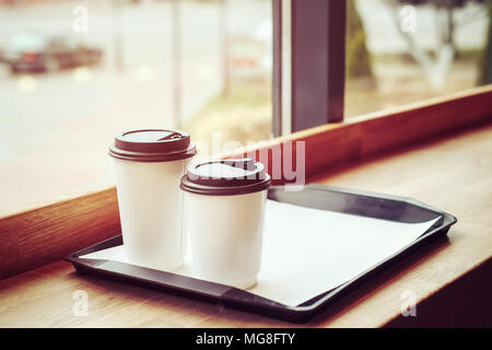 Two glasses of coffee on a tray in a cafe. Toned image Stock Photo