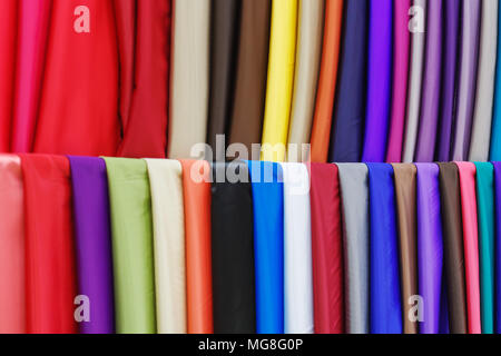 multicolored silk fabric background. texture of colored pieces of fabric Stock Photo