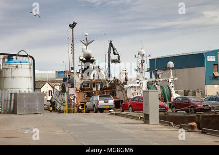 Repairs and maintenance being carried out on trawlers at Fraserburgh showing trawling gear and nets Stock Photo