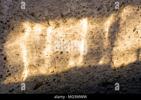 bright sunbeam on a rough concrete wall Stock Photo