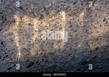 soft sunbeam on a rough concrete wall Stock Photo