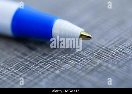 Closeup of a ballpoint pen, shallow depth of field with focus on top of pen. Ball point biro pen in macro photo key on fancy background. Stock Photo