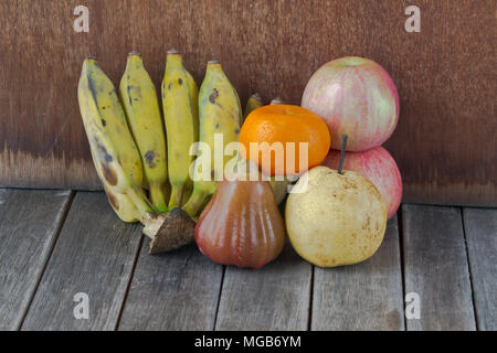 apple, bananas, orange and rose apple on gray old wooden table Stock Photo