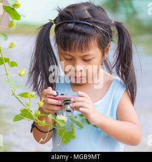 little asia girl taking photo Stock Photo