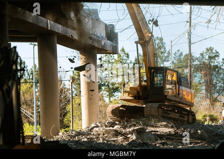 A crane knocks down a section of I-85 just imploded, following the collapse of the I-85 North bridge from a fire, on April 1, 2017 in Atlanta, GA. Stock Photo