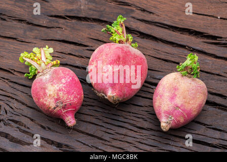 Radish taproots on the wooden background. Stock Photo