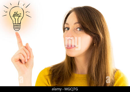 Woman pointing to illustration of light bulb. Idea concept Stock Photo