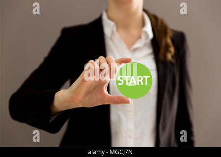 Young businesswoman holding virtual button start. New start, beginning, business concept Stock Photo