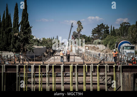 Two workers looking down the under construction Hostetter Trench on the BART to Silicon Valley Berryessa Extension project in San Jose, California Stock Photo