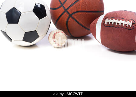 A group of assorted sports balls on white background with copy space.  Including a soccer ball a baseball a basketball and an American football. Stock Photo
