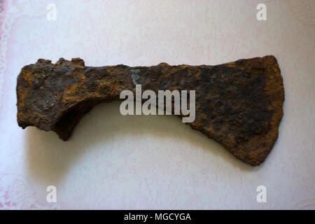 Photo depicts iron rusty but very sharp old wooden ax blade, placed on a timber with chopping trace. Axeman equipment tool concept. Ax and ax handle,  Stock Photo
