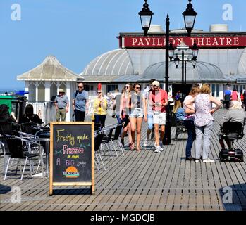 Young teenagers enjoying the hot sunny weather on Cromer pier Norfolk England UK Stock Photo