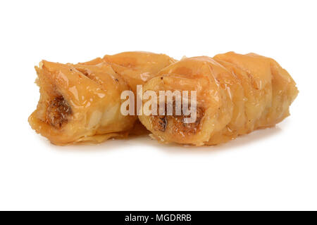 Two pieces of sweet dessert roll baklava in sugary syrup isolated on white background. Stock Photo