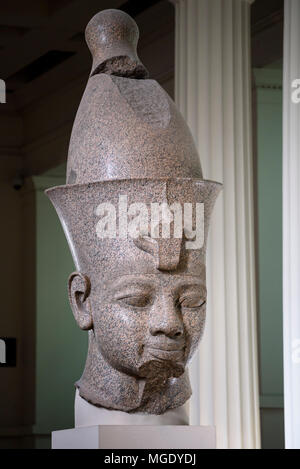 London. England. British Museum. Colossal red granite statue believed to be Egyptian Pharaoh Amenhotep III wearing a double crown (Pschent) Stock Photo