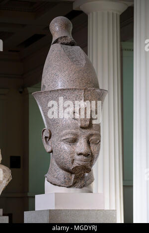 London. England. British Museum. Colossal red granite statue believed to be Egyptian Pharaoh Amenhotep III wearing a double crown (Pschent) Stock Photo