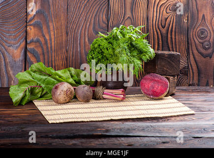 Still life of beetroot and beet leaves on wooden background Stock Photo