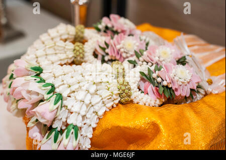 Thai traditional wedding accessories, white garland made from jasmin on golden tray Stock Photo