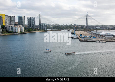 Sydney, NSW, Australia-December 7,2016: Sailboat and jon boat in the harbour with view of the Anzac cable-stayed bridge in Sydney, Australia Stock Photo