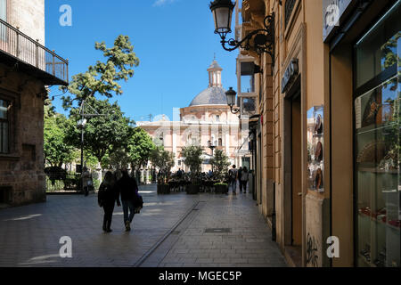 Street scene, North Cuitat Vella district, with landmark building Basilica de los Desamparados in Plaza de la Virgen, Valencia, Spain Stock Photo